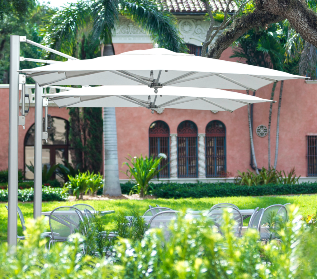 Tuuci Sonnenschirm Bay Master Cantilever 3x3M in weiß mit einem Aluminium Mast steht in einem italienischem Garten.